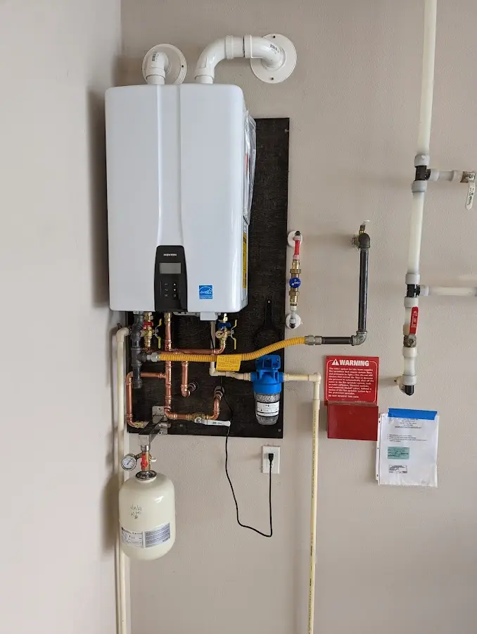 Professional plumber installing copper piping in a Oakleaf Plantation home